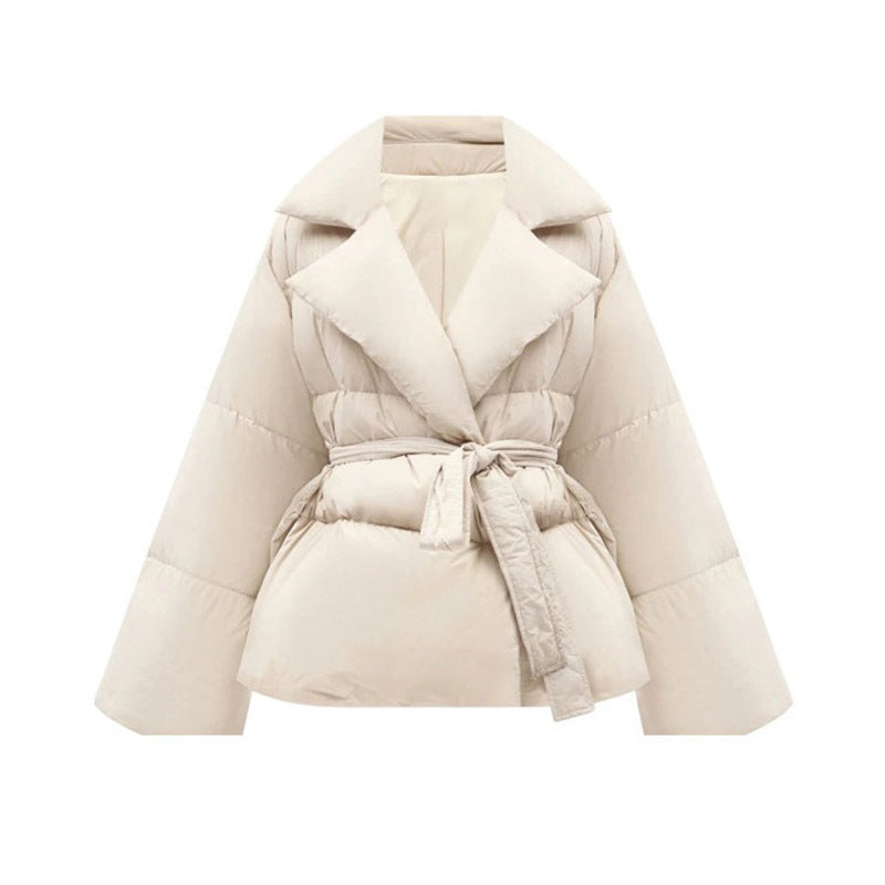 Beige puffer jacket with a belt on a white background