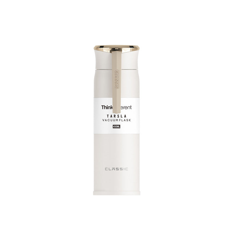White vacuum flask with gold cap on a white background