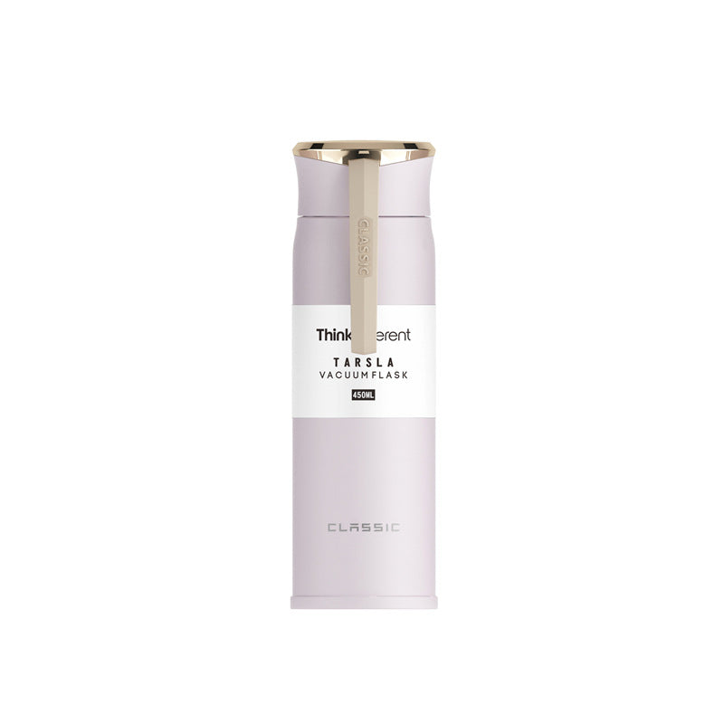 Vacuum flask with gold cap on a white background