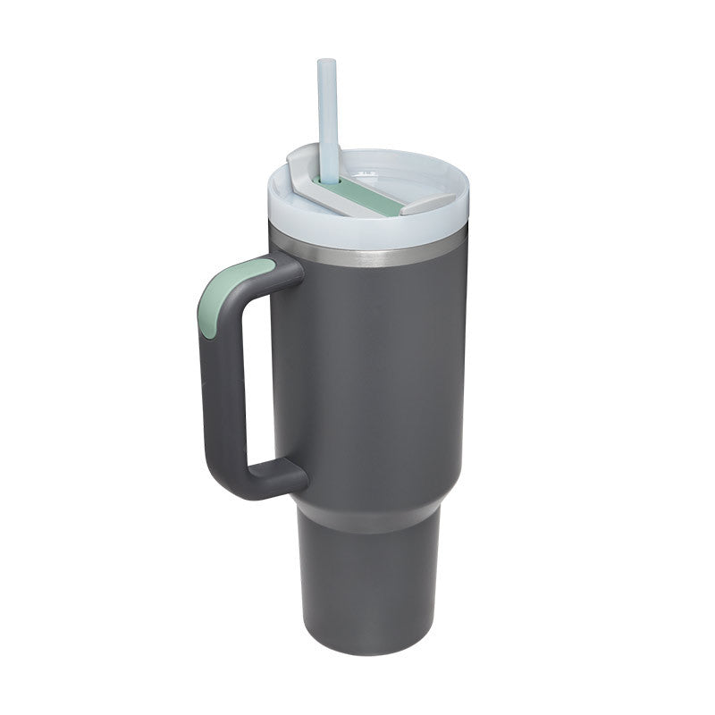Gray insulated tumbler with a handle and straw lid on a white background