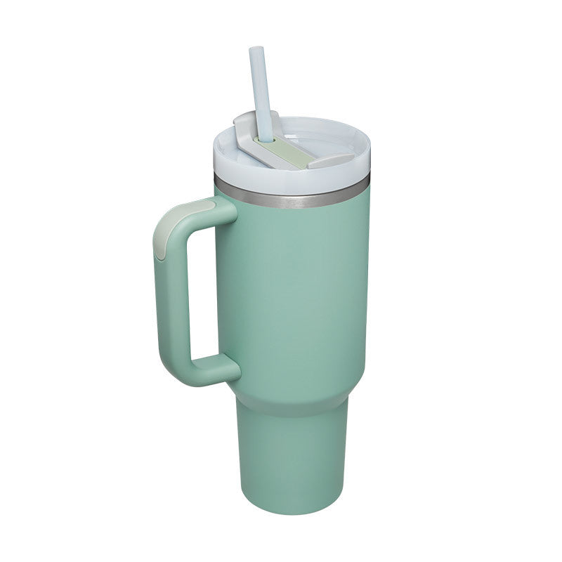 Mint green tumbler with handle and straw on a white background